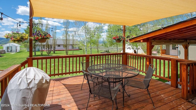 deck featuring grilling area and a yard