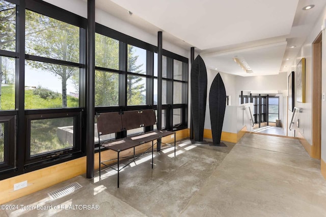 interior space featuring plenty of natural light and concrete floors