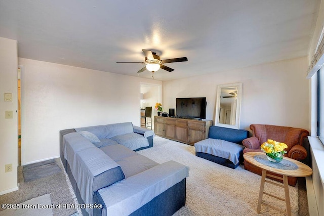 carpeted living room featuring ceiling fan