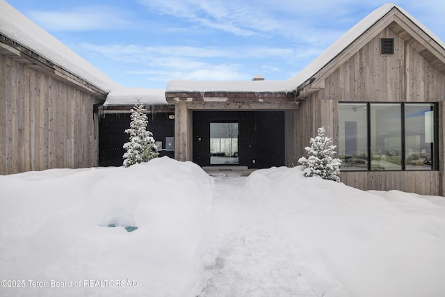 view of snow covered property entrance