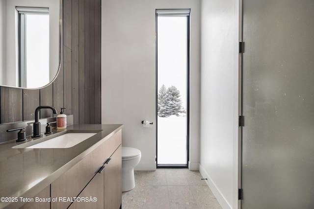 bathroom with tile patterned flooring, vanity, toilet, and a shower with shower door