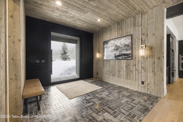 foyer with wooden walls and wood ceiling