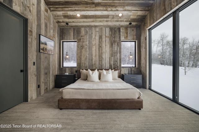 carpeted bedroom with beam ceiling