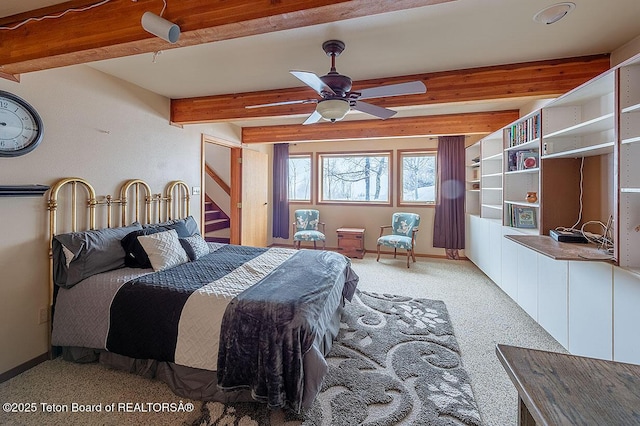 bedroom with beamed ceiling, baseboards, and light carpet