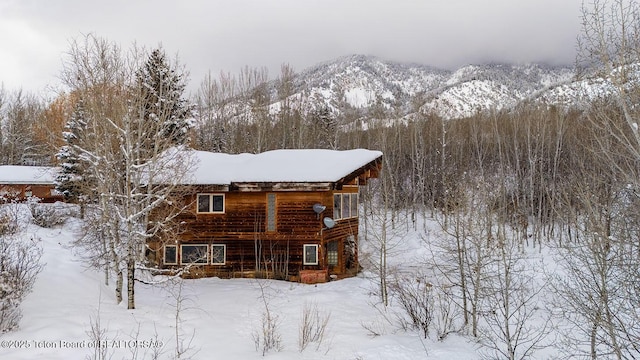 snow covered property featuring a mountain view