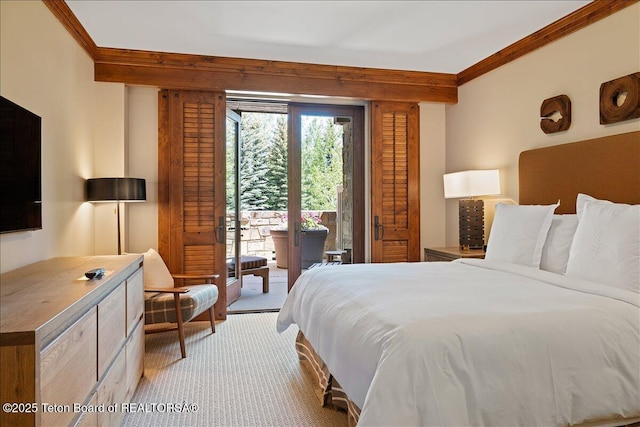 carpeted bedroom featuring access to exterior and ornamental molding