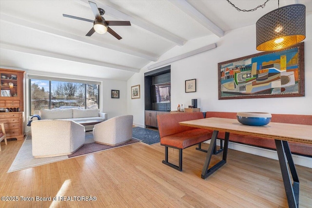 office area with ceiling fan, vaulted ceiling with beams, and wood-type flooring