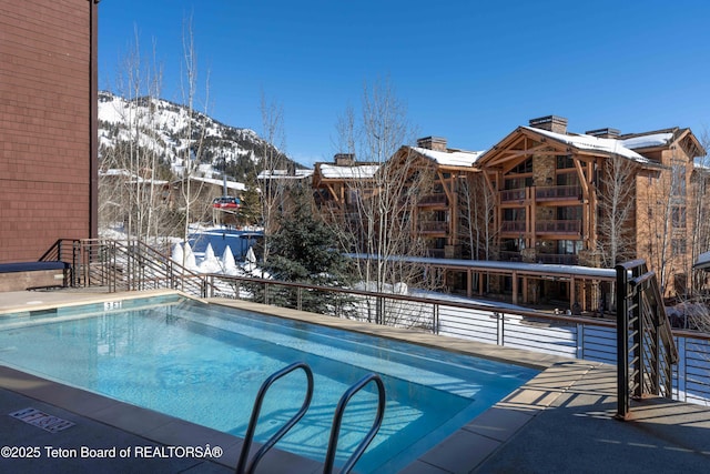 snow covered pool with a mountain view