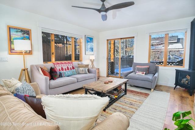 living room featuring ceiling fan and hardwood / wood-style flooring