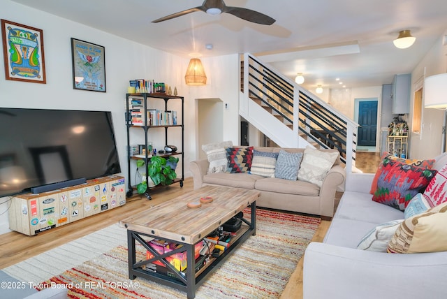 living room featuring ceiling fan and light wood-type flooring