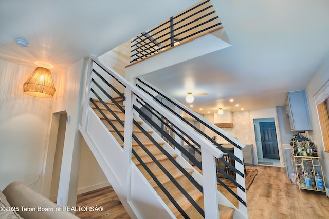 stairway featuring wood-type flooring