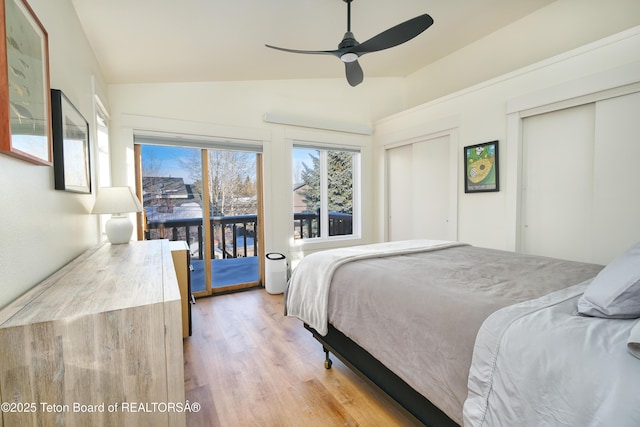 bedroom featuring light hardwood / wood-style floors, ceiling fan, a closet, access to exterior, and lofted ceiling