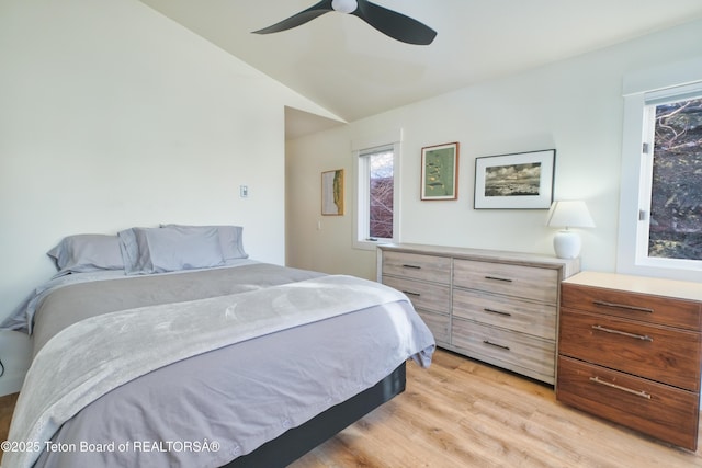 bedroom featuring vaulted ceiling, ceiling fan, and light wood-type flooring