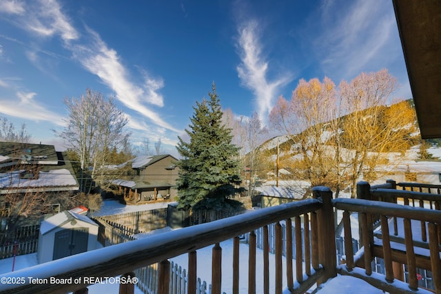 view of snow covered back of property