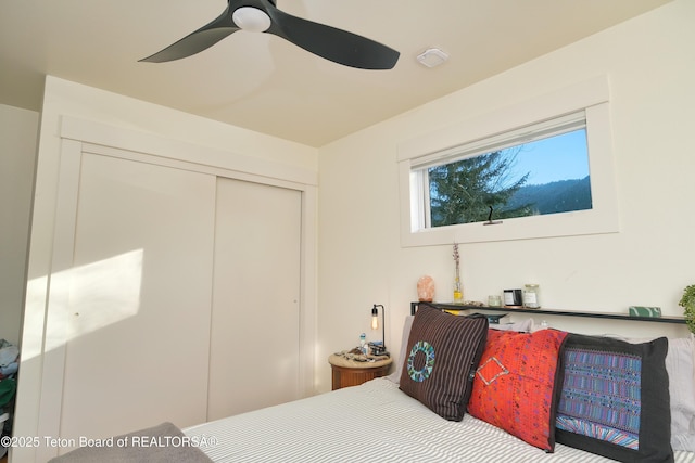 bedroom featuring ceiling fan and a closet