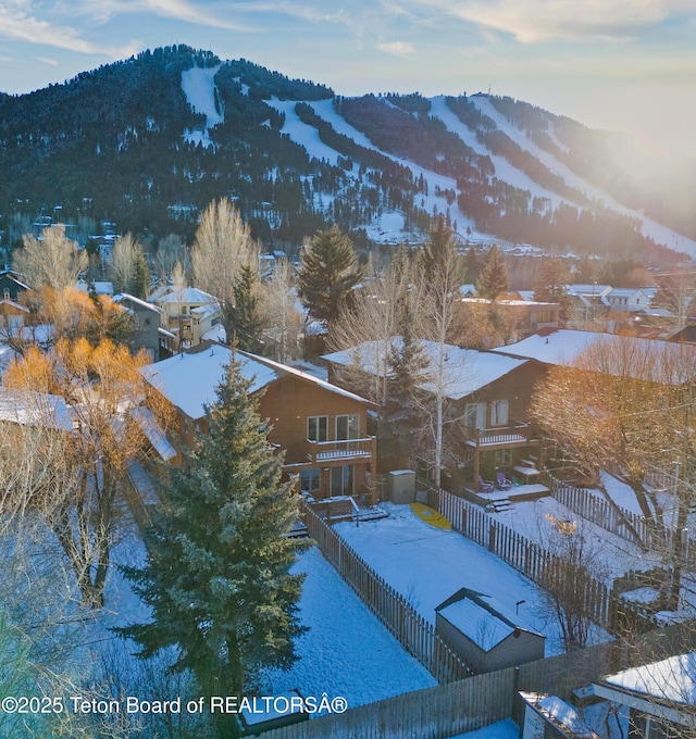 snowy aerial view with a mountain view