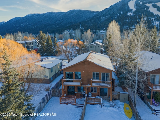 snowy aerial view featuring a mountain view