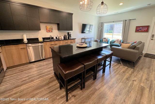 kitchen with dishwasher, hanging light fixtures, a notable chandelier, light hardwood / wood-style floors, and sink