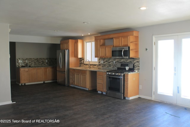 kitchen featuring sink, dark hardwood / wood-style floors, backsplash, and appliances with stainless steel finishes