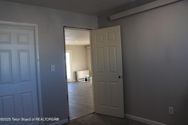 interior space featuring dark colored carpet