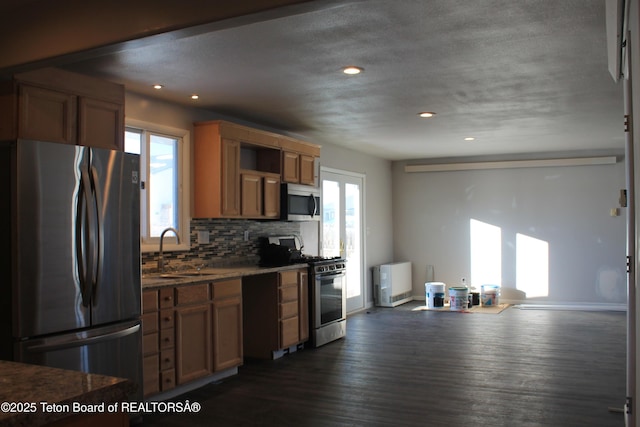 kitchen with sink, stainless steel appliances, dark hardwood / wood-style flooring, and tasteful backsplash