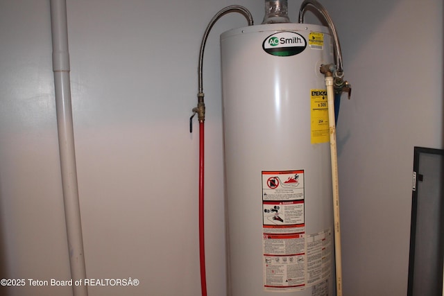 utility room featuring water heater