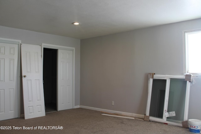 unfurnished bedroom with carpet floors