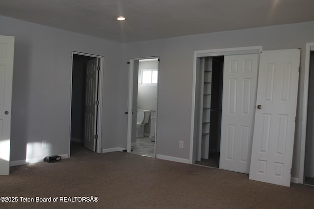 unfurnished bedroom with carpet flooring and connected bathroom