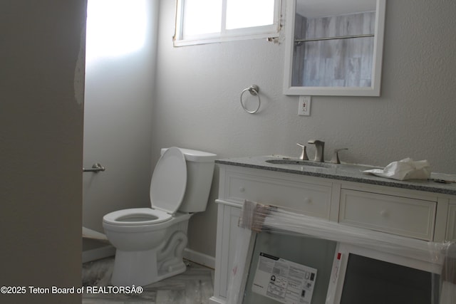 bathroom featuring toilet and vanity