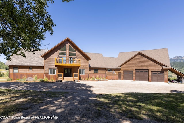 view of front of home with a garage and a balcony