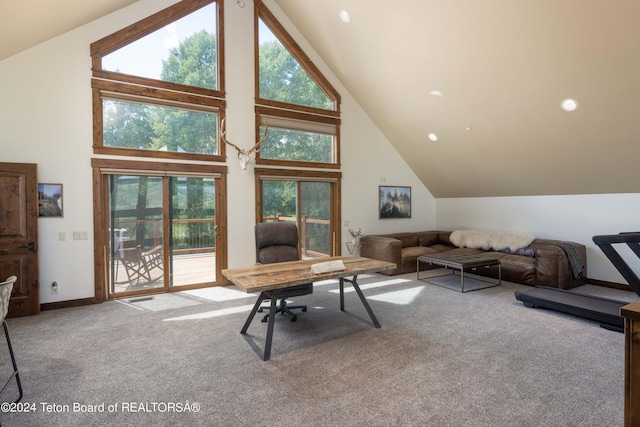 carpeted home office featuring high vaulted ceiling