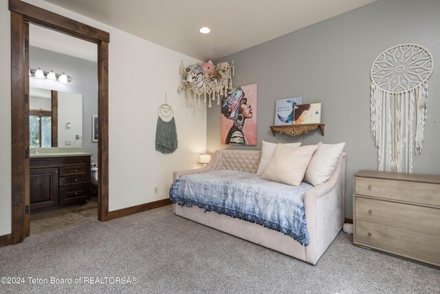 carpeted bedroom with connected bathroom