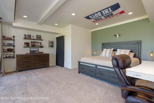 carpeted bedroom with beamed ceiling