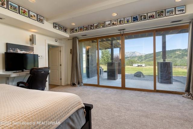 carpeted bedroom with access to exterior, a mountain view, and beamed ceiling