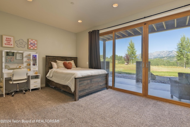 bedroom featuring a mountain view, access to exterior, and carpet floors