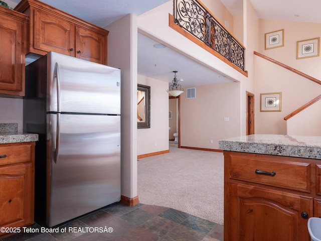 kitchen featuring dark carpet and stainless steel fridge