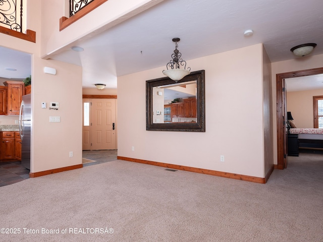 unfurnished living room featuring carpet flooring