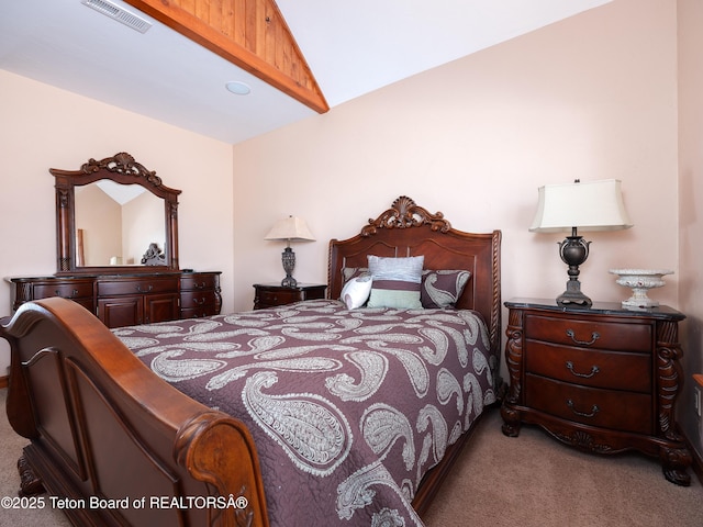 carpeted bedroom with lofted ceiling