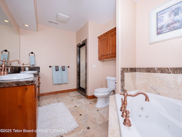 bathroom with toilet, tiled tub, and vanity