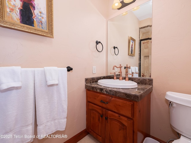 bathroom featuring toilet and vanity