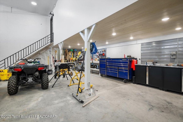 garage with a workshop area and recessed lighting