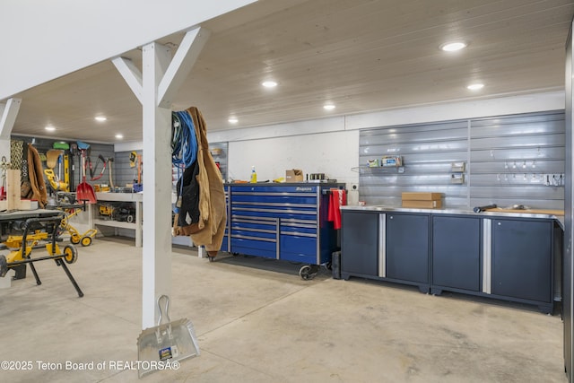 miscellaneous room featuring concrete flooring, recessed lighting, wooden ceiling, and a workshop area