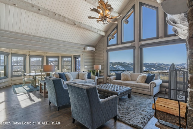 living area featuring rustic walls, plenty of natural light, beamed ceiling, and wood finished floors