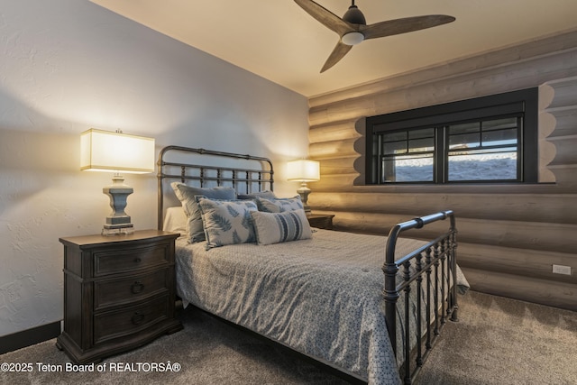 carpeted bedroom featuring rustic walls and a ceiling fan