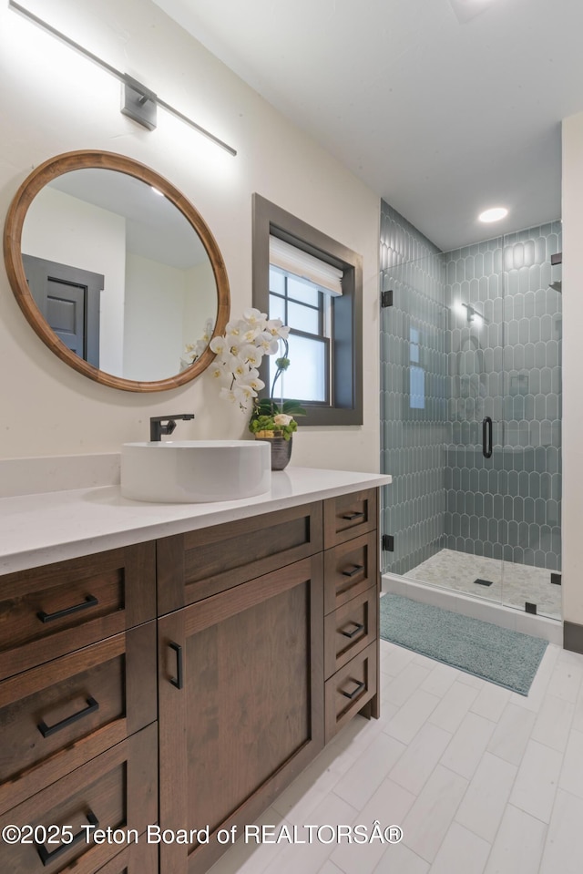 full bathroom featuring a stall shower and vanity