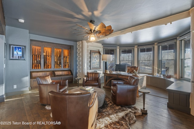 sitting room featuring wood-type flooring, baseboards, and ceiling fan