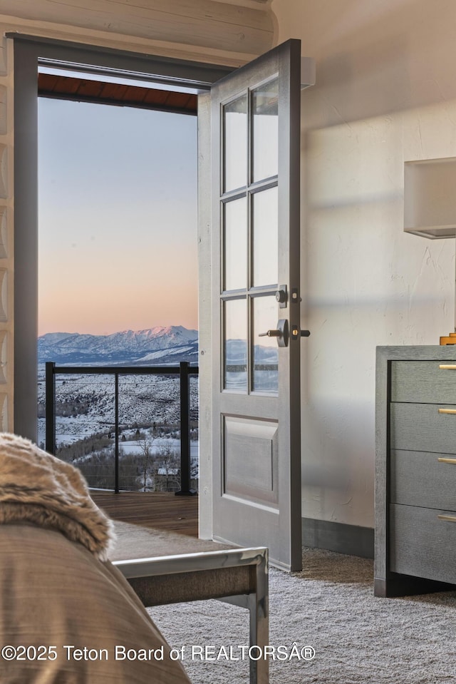 bedroom with multiple windows and a mountain view