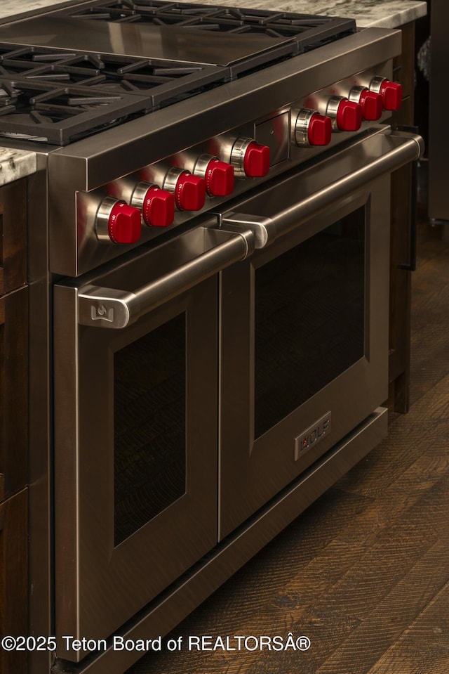 room details with double oven range and dark brown cabinetry