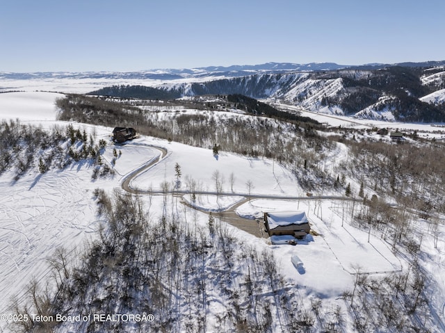 snowy aerial view featuring a mountain view