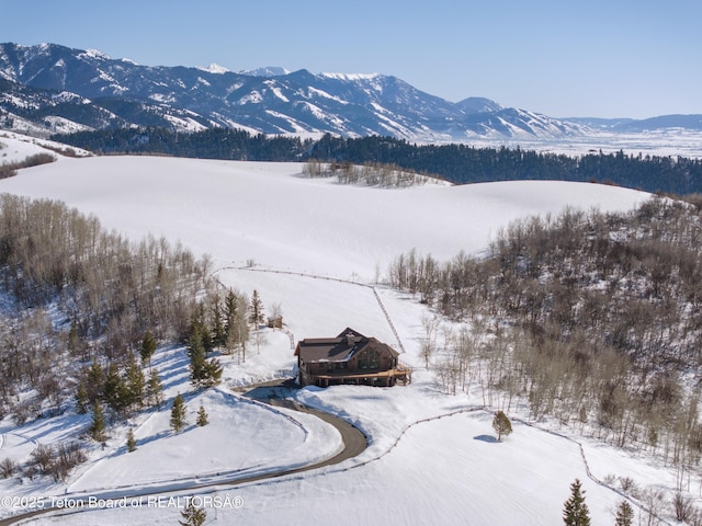 snowy aerial view with a mountain view